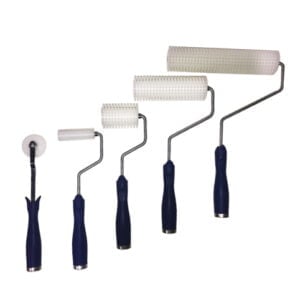 Assorted paint rollers on white background