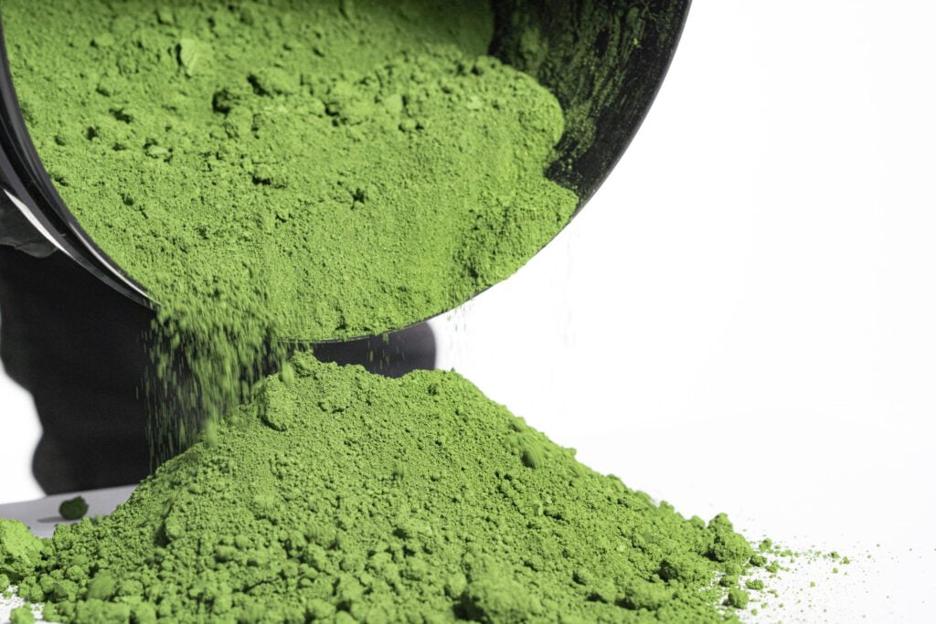 Pouring vibrant green powder from container