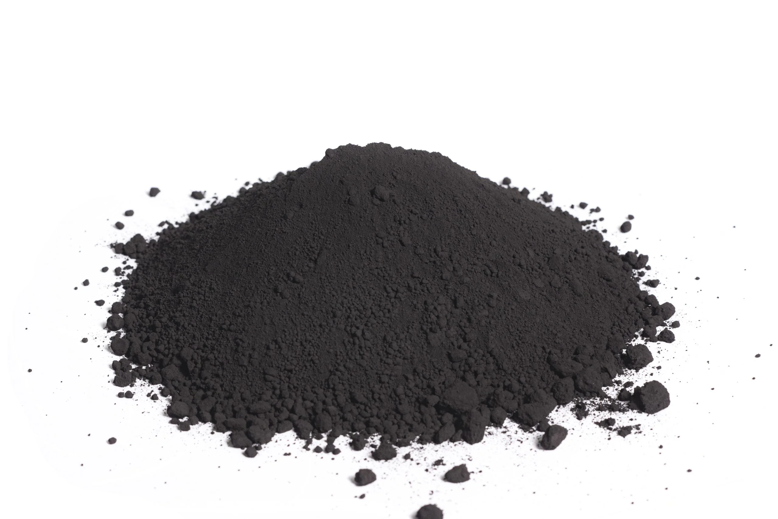 Pile of black powder on white background.
