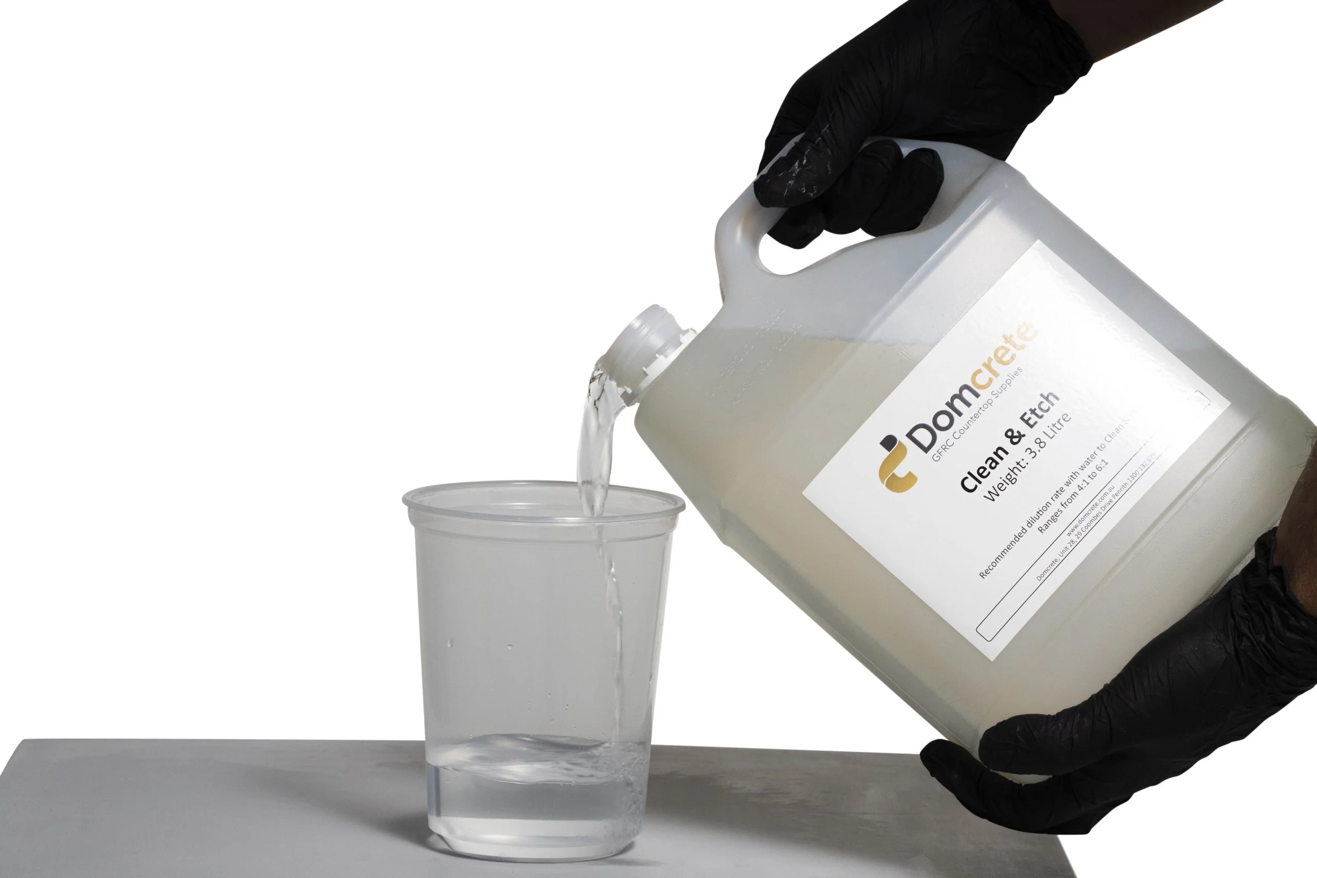 Pouring Domcrete Clean & Etch into cup.