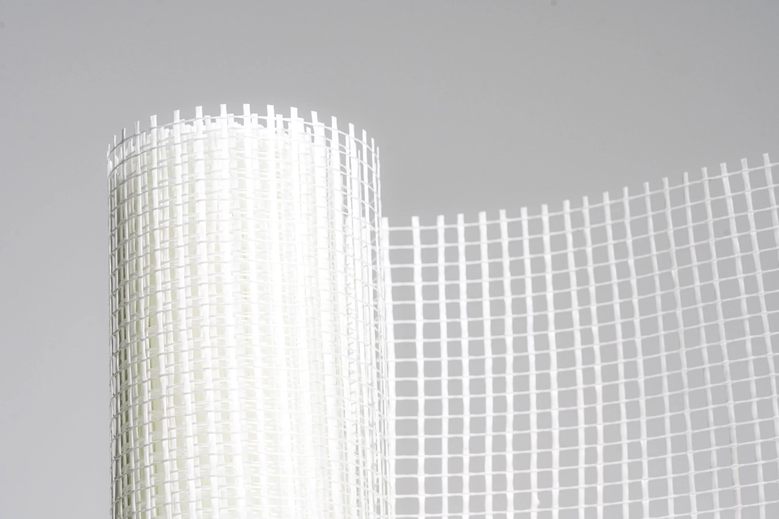 Roll of white grid mesh fabric