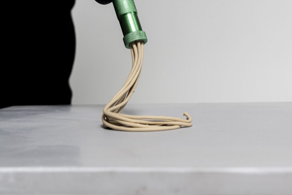 Extruding clay from handheld tool