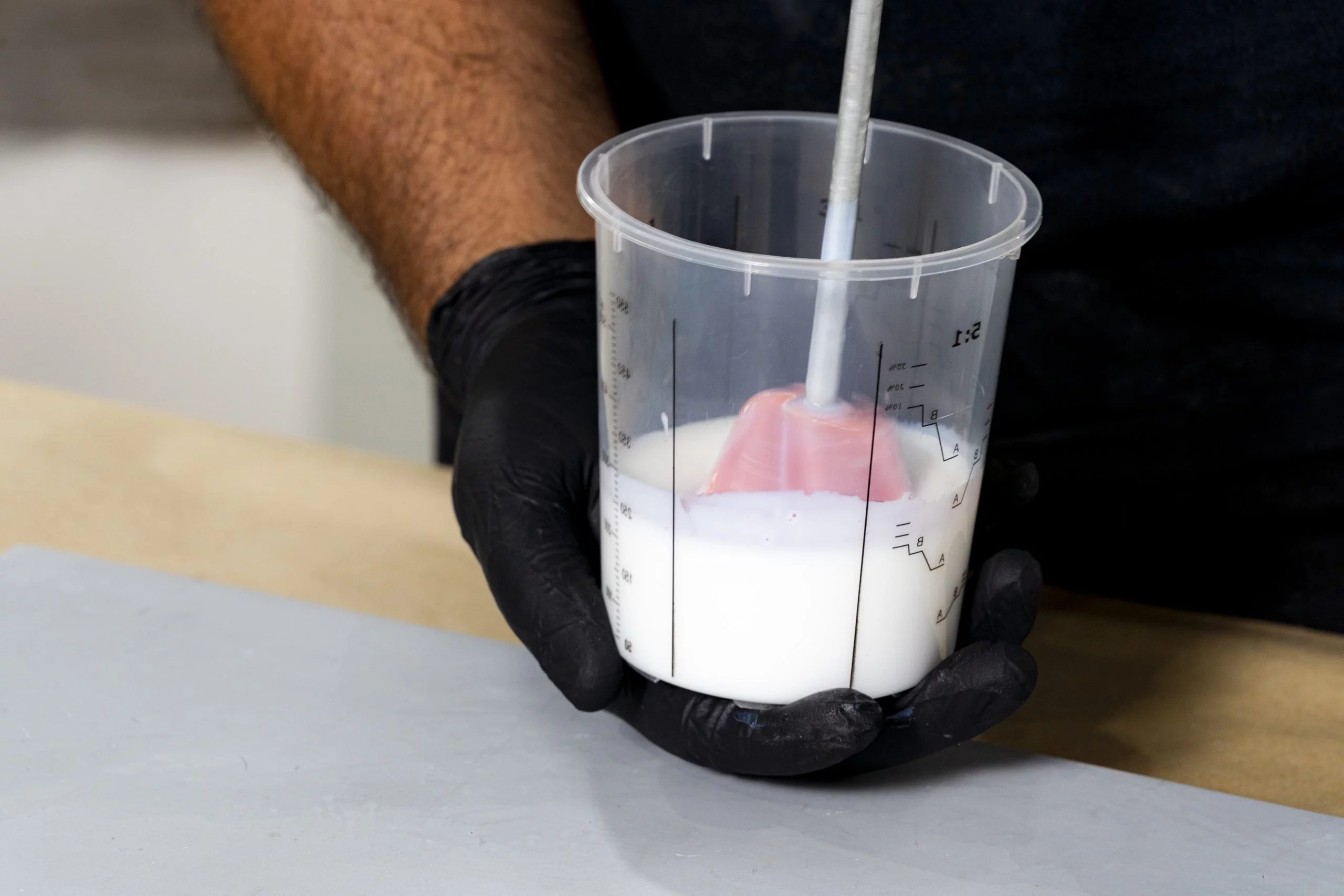 Mixing a white solution in a measuring cup