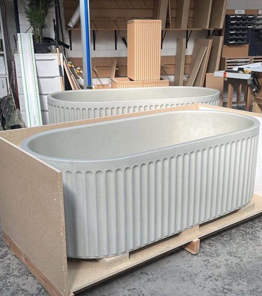 Modern freestanding bathtubs in workshop setting.