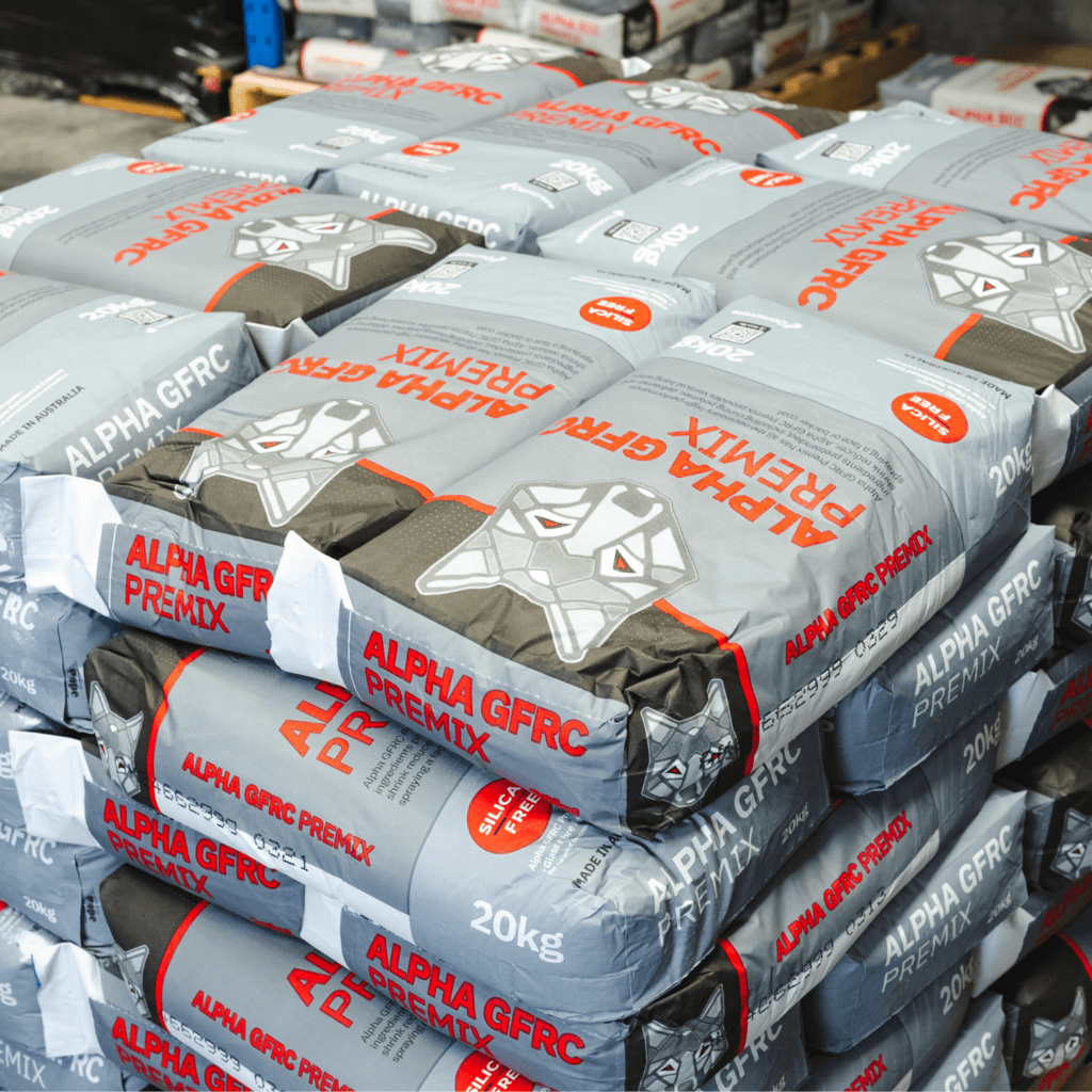 Stacked Alpha GFRC Premix cement bags in warehouse.