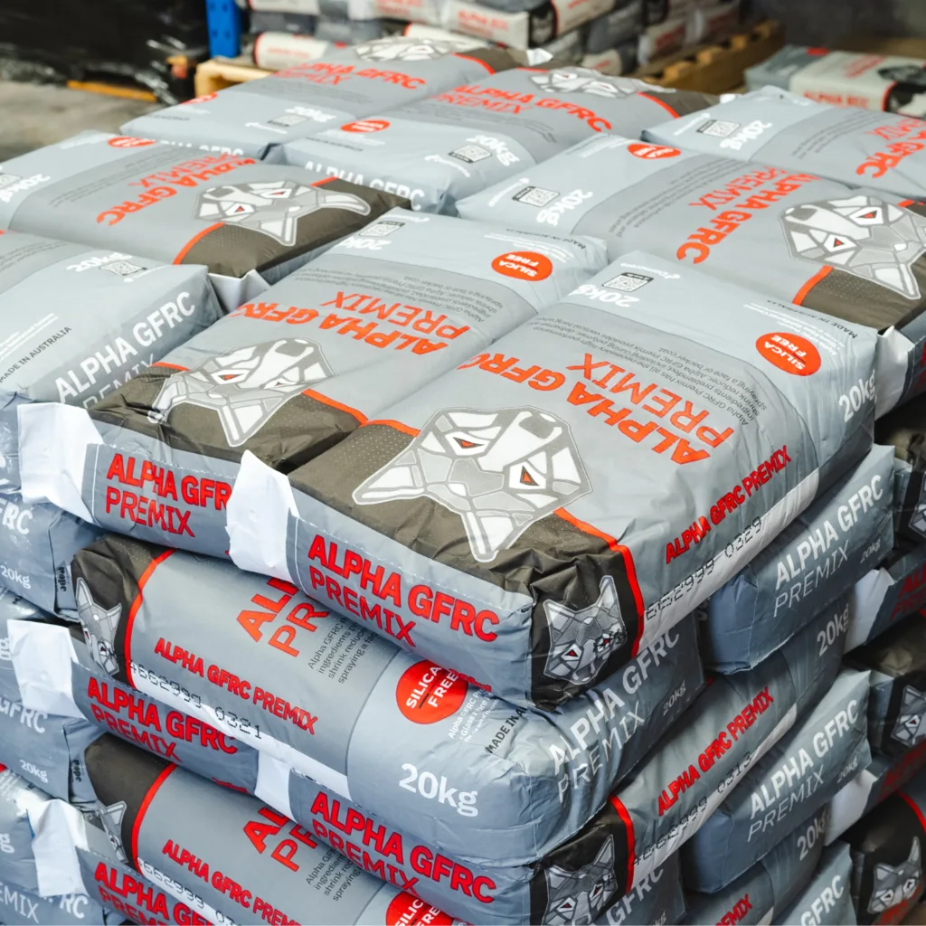 Stacked Alpha GFRC Premix cement bags in warehouse.