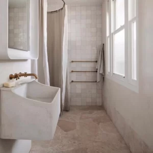 Modern bathroom with tiles and a curtain shower.
