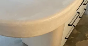 Round concrete table with black handles