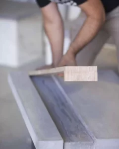 Person sanding wood with a sander.