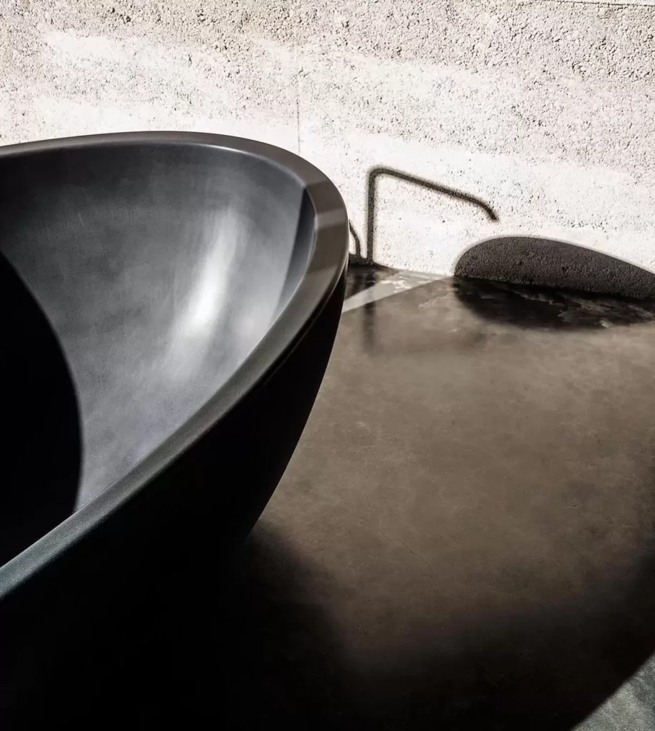 Modern dark bathtub in minimalist bathroom.