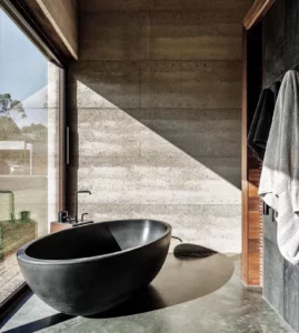 Modern bathroom with freestanding black bathtub.