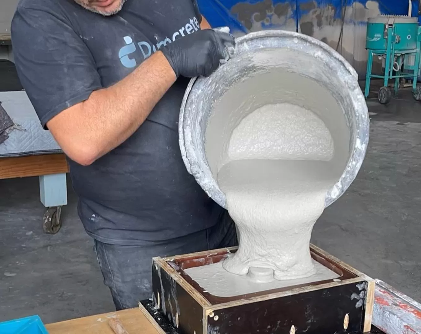 Man pouring concrete into mould