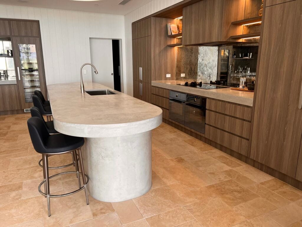 Modern kitchen with stone island and wooden cabinetry.
