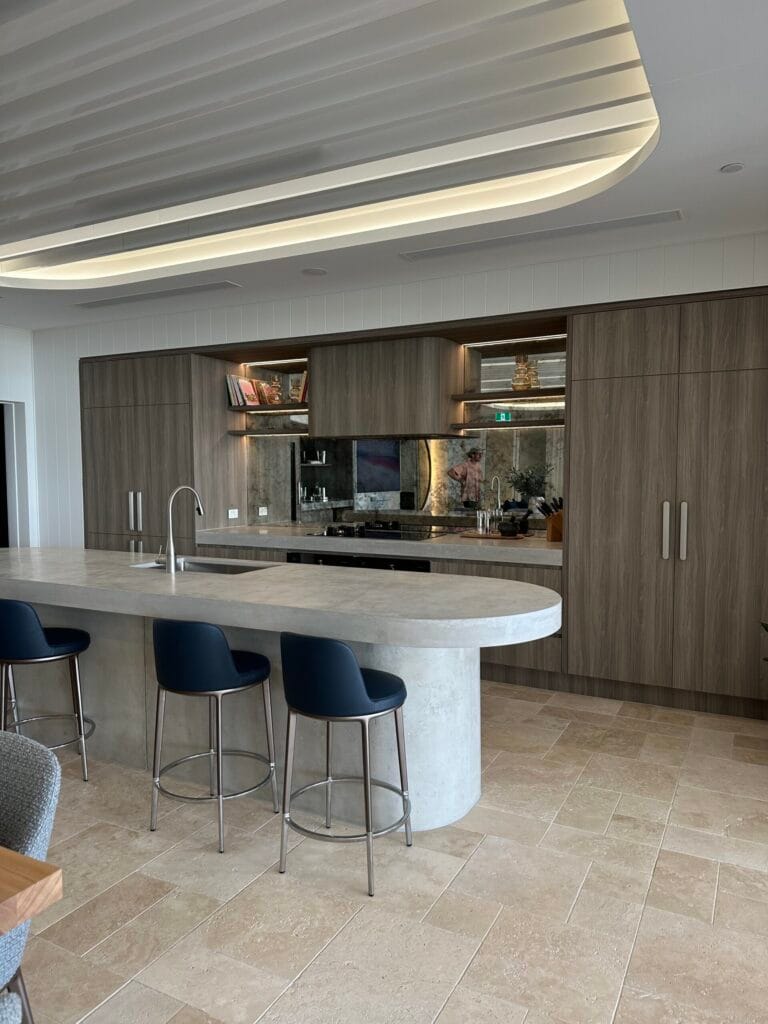 Modern kitchen with island and bar stools.