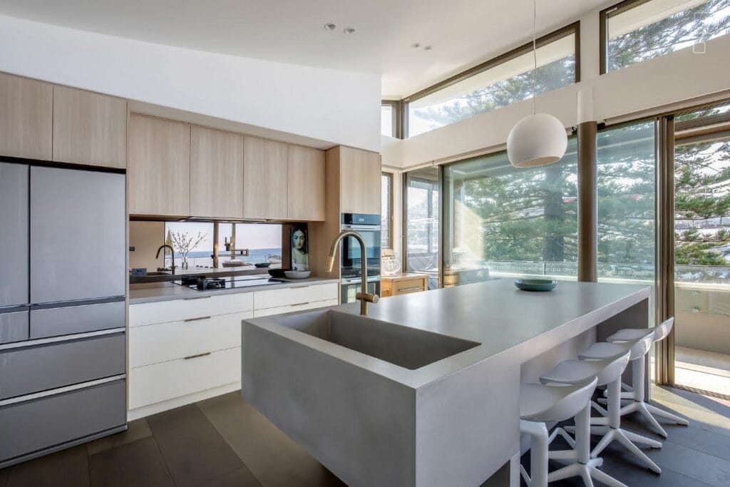 Modern kitchen with island and bar stools.